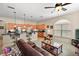 Living room with a brown leather couch and large windows at 3828 Arbordale Ct, Leesburg, FL 34748