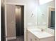 Well-lit bathroom with a white vanity, a mirror, and a glimpse into a walk-in closet at 2114 Waitman, Leesburg, FL 34748