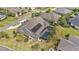 An aerial view showcasing the home's solar panels, screened pool, landscaping and neighborhood at 4049 Nostalgia Ter, The Villages, FL 32163