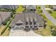 Charming single-Gathering home with a three-car garage, manicured lawn, and an inviting front porch at 4049 Nostalgia Ter, The Villages, FL 32163