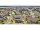 Aerial view of homes with solar panels and a community near the lake at 4049 Nostalgia Ter, The Villages, FL 32163