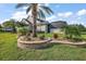 Well-maintained backyard landscaping with tiered beds and a variety of plants and shrubs at 4049 Nostalgia Ter, The Villages, FL 32163