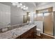 Bathroom featuring a granite countertop, single sink vanity, and glass door shower at 4049 Nostalgia Ter, The Villages, FL 32163