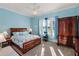 Bedroom with blue walls, carpeting, and natural light at 4049 Nostalgia Ter, The Villages, FL 32163