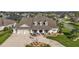 Charming single-Gathering home with a three-car garage, manicured lawn, and an inviting front porch at 4049 Nostalgia Ter, The Villages, FL 32163
