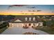 Charming home with a three-car garage, covered porch, and manicured landscaping, ideal for suburban living at 4049 Nostalgia Ter, The Villages, FL 32163