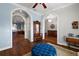 Foyer leading to the living spaces, featuring wood-look ceramic tile floors and decorative furnishings at 4049 Nostalgia Ter, The Villages, FL 32163