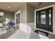 Inviting front porch with a seating area, stylish door with sidelights, and a modern exterior at 4049 Nostalgia Ter, The Villages, FL 32163
