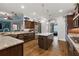 Large kitchen with granite countertops, dark cabinets, a center island, stainless steel appliances, and a sink at 4049 Nostalgia Ter, The Villages, FL 32163