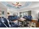 Expansive living room with modern furniture, a decorative rug, and access to the kitchen and outdoor spaces at 4049 Nostalgia Ter, The Villages, FL 32163