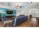 Comfortable living room with a flat-screen TV and blue accent wall, leading to a home entryway at 4049 Nostalgia Ter, The Villages, FL 32163