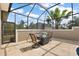 Covered patio with comfortable seating offers a relaxing spot to enjoy the outdoors and a screen for privacy at 4049 Nostalgia Ter, The Villages, FL 32163