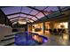Beautiful screened pool area with an open-concept bar, barbecue, and dining area, perfect for enjoying the outdoors at 4049 Nostalgia Ter, The Villages, FL 32163