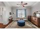 Cozy sitting room features vintage furniture, patterned rug and a window with natural light at 4049 Nostalgia Ter, The Villages, FL 32163