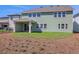 Backyard view of the home with a covered patio, yard, and modern siding at 6208 Trailblaze Bnd, St Cloud, FL 34771
