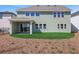 View of the back of the home with a covered patio and green lawn with freshly laid straw at 6208 Trailblaze Bnd, St Cloud, FL 34771