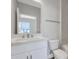 Modern bathroom with a white vanity, countertop, and tile accents at 6208 Trailblaze Bnd, St Cloud, FL 34771