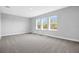 Bright bedroom featuring carpet, with natural light from three windows at 6208 Trailblaze Bnd, St Cloud, FL 34771
