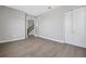 Spacious bedroom featuring modern gray vinyl floors, large windows, and closet at 6208 Trailblaze Bnd, St Cloud, FL 34771