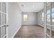 Spacious bedroom featuring modern gray vinyl floors, large windows, and closet at 6208 Trailblaze Bnd, St Cloud, FL 34771