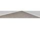 Corner view of neutral-toned carpet flooring complemented by white baseboards at 6208 Trailblaze Bnd, St Cloud, FL 34771