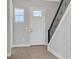Entryway features a view of a staircase with an iron railing and a window for natural light at 6208 Trailblaze Bnd, St Cloud, FL 34771