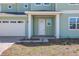 Charming two-story home with a brick driveway, attached two-car garage, and covered front porch at 6208 Trailblaze Bnd, St Cloud, FL 34771