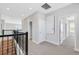 Upstairs hallway with neutral carpet, iron railing and a view of windows at 6208 Trailblaze Bnd, St Cloud, FL 34771