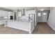 Bright open-concept kitchen features white cabinetry, stainless appliances, and a large center island at 6208 Trailblaze Bnd, St Cloud, FL 34771