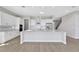 Modern kitchen boasts white cabinets, an island with a sink, and stainless steel appliances at 6208 Trailblaze Bnd, St Cloud, FL 34771