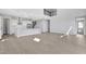 Bright, open living area boasts high ceilings, modern flooring, and a view of the kitchen at 6208 Trailblaze Bnd, St Cloud, FL 34771