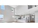 Spacious living room with high ceilings, bright light, and views into the modern kitchen at 6208 Trailblaze Bnd, St Cloud, FL 34771