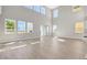 Large living area with high ceilings and plentiful windows, leading into the kitchen at 6208 Trailblaze Bnd, St Cloud, FL 34771