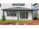 Covered back porch with green columns and sliding door to backyard at 6608 Quest St, St Cloud, FL 34771