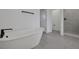 Bathroom with a soaking tub and a glass shower with matte black hardware at 6608 Quest St, St Cloud, FL 34771