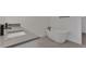 Bright bathroom featuring a sleek vanity, and a modern standalone tub with matte black fixtures at 6608 Quest St, St Cloud, FL 34771