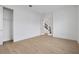 Bright bedroom featuring hardwood floors, closet, and access to the stairway via a glass door at 6608 Quest St, St Cloud, FL 34771