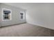 Spacious bedroom features two windows providing ample natural light, neutral carpet, and freshly painted white walls at 6608 Quest St, St Cloud, FL 34771