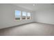 This bedroom features plush carpeting and three windows with a view of the landscape at 6608 Quest St, St Cloud, FL 34771