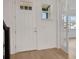 Bright foyer with light hardwood floors, a white door, and glass French doors leading to another room at 6608 Quest St, St Cloud, FL 34771