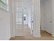 Bright hallway with French doors and wood-look flooring at 6608 Quest St, St Cloud, FL 34771