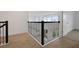 View of the hallway with dark metal railing and wood flooring, providing a modern aesthetic at 6608 Quest St, St Cloud, FL 34771