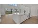 Modern kitchen featuring a large island, white cabinets, and stainless steel appliances, perfect for cooking at 6608 Quest St, St Cloud, FL 34771