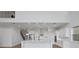 Bright, open kitchen with white cabinetry, stainless steel appliances, and large center island at 6608 Quest St, St Cloud, FL 34771
