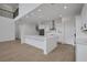 Bright kitchen with an island, pendant lights, stainless steel appliances, and sleek white cabinets at 6608 Quest St, St Cloud, FL 34771