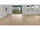 Spacious living room with wood-look floors and sliding glass doors to backyard at 6608 Quest St, St Cloud, FL 34771