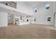 Open living area with abundant natural light, featuring hardwood floors and a view of the modern kitchen at 6608 Quest St, St Cloud, FL 34771