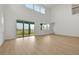 Bright living room featuring luxury vinyl plank flooring, many windows, and access to the rear patio at 6608 Quest St, St Cloud, FL 34771