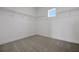 Spacious walk-in closet with carpeted floors, wire shelving and a single window for natural light at 6608 Quest St, St Cloud, FL 34771