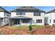 A two-story home featuring solar panels and a covered patio at 6612 Quest St, St Cloud, FL 34771